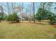 Wooded backyard with a large grassy area at 535 Tyson St, Charlotte, NC 28209