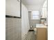 Clean bathroom with gray tile and a shower/tub combo at 535 Tyson St, Charlotte, NC 28209