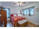 Bedroom with red floral bedding and a ceiling fan at 535 Tyson St, Charlotte, NC 28209