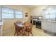 Cozy kitchen with wood table, white cabinets, and black appliances at 535 Tyson St, Charlotte, NC 28209