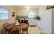 White kitchen cabinets and appliances, with a wood table at 535 Tyson St, Charlotte, NC 28209