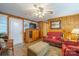 Living room with wood paneling, a TV, and ample seating at 535 Tyson St, Charlotte, NC 28209