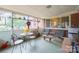 Relaxing screened porch with seating area, table, and stained glass accents at 535 Tyson St, Charlotte, NC 28209