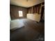 Unfinished bedroom with hardwood floors and large window at 543 Salisbury St, Wadesboro, NC 28170