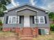 Gray house with brick steps and a white front door at 543 Salisbury St, Wadesboro, NC 28170