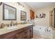 Bathroom with double vanity, large garden tub, and separate shower at 5767 Dove Point Dr, Concord, NC 28025