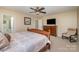 Spacious bedroom with a dresser, large bed, and ceiling fan at 5767 Dove Point Dr, Concord, NC 28025