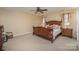 Primary bedroom with ceiling fan and wood furniture at 5767 Dove Point Dr, Concord, NC 28025