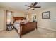 Primary bedroom with ceiling fan and wood furniture at 5767 Dove Point Dr, Concord, NC 28025