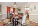 Bright dining room with a dark wood table and neutral chairs at 5767 Dove Point Dr, Concord, NC 28025