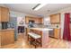 Kitchen with oak cabinets, stainless steel appliances, and island at 5767 Dove Point Dr, Concord, NC 28025