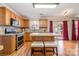 Kitchen with oak cabinets, stainless steel appliances, and island with seating at 5767 Dove Point Dr, Concord, NC 28025