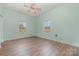 Spacious bedroom with light walls, wood flooring, and ceiling fan at 6 Walnut St, Great Falls, SC 29055