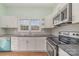 Modern kitchen with white cabinets and stainless steel appliances at 6 Walnut St, Great Falls, SC 29055