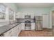 Modern kitchen featuring stainless steel appliances and white cabinetry at 6 Walnut St, Great Falls, SC 29055