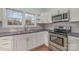 Modern kitchen with white cabinets and stainless steel appliances at 6 Walnut St, Great Falls, SC 29055