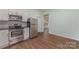 Bright kitchen with stainless steel appliances and wood flooring at 6 Walnut St, Great Falls, SC 29055