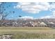 View of homes from backyard with a sloped lawn and fence at 6297 Raven Rock Dr, Denver, NC 28037