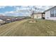 Landscaped backyard with a sloped lawn and black fence at 6297 Raven Rock Dr, Denver, NC 28037