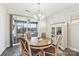 Bright dining room with hardwood floors and access to a screened porch at 6297 Raven Rock Dr, Denver, NC 28037