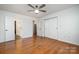 Spacious bedroom with hardwood floors and multiple closets for storage at 670 Sylvan Sw St, Concord, NC 28025