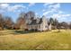 Exterior angle view of a charming two-story home with manicured lawn and mature landscaping at 670 Sylvan Sw St, Concord, NC 28025