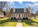 Charming two-story home with dormer windows, shutters, and a well-manicured lawn offers classic curb appeal at 670 Sylvan Sw St, Concord, NC 28025