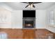 Bright and airy living room showcasing a fireplace, hardwood floors, and ample space at 670 Sylvan Sw St, Concord, NC 28025