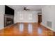 Inviting living room boasts a fireplace, hardwood floors, and sun-filled windows at 670 Sylvan Sw St, Concord, NC 28025