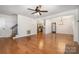 Spacious living room with hardwood floors, staircase, and natural light. French doors lead to Kitchen at 670 Sylvan Sw St, Concord, NC 28025