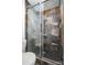 Modern tiled shower with glass door and black shower head at 670 Sylvan Sw St, Concord, NC 28025