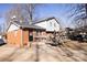 Home's back features a deck, brickwork, and partial view of the backyard at 6710 Elm Forest Dr, Charlotte, NC 28212