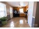 Kitchen with wood cabinets, black appliances, and tile flooring at 6710 Elm Forest Dr, Charlotte, NC 28212