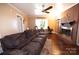 Living room with fireplace, hardwood floors, and comfy reclining sofa at 6710 Elm Forest Dr, Charlotte, NC 28212