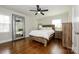 Cozy bedroom with hardwood floors and a full-size bed at 7445 Briardale Dr, Charlotte, NC 28212