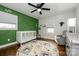 Bedroom with green accent wall, crib, and plenty of natural light at 7445 Briardale Dr, Charlotte, NC 28212