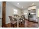 Cozy dining area with a wood table and four chairs near the kitchen at 7445 Briardale Dr, Charlotte, NC 28212