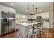 Modern kitchen featuring white cabinets, stainless steel appliances, and an island at 7445 Briardale Dr, Charlotte, NC 28212