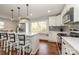 Renovated kitchen boasting white cabinets, stainless steel appliances, and an island at 7445 Briardale Dr, Charlotte, NC 28212