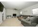 Relaxing living room with sectional sofa, fireplace, and plenty of natural light at 7445 Briardale Dr, Charlotte, NC 28212