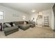 Cozy living room featuring a sectional sofa and access to upper level at 7445 Briardale Dr, Charlotte, NC 28212