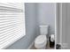 Small bathroom with toilet and window at 7822 Meridale Forest Dr, Charlotte, NC 28269