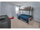 Bedroom with a bunk bed, dresser and carpet flooring at 7822 Meridale Forest Dr, Charlotte, NC 28269