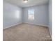 Bright bedroom with neutral walls and carpet at 7822 Meridale Forest Dr, Charlotte, NC 28269