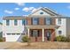 Two-story brick and siding home with a front porch and attached two-car garage at 7822 Meridale Forest Dr, Charlotte, NC 28269