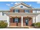 Two-story brick front elevation of home with covered porch at 7822 Meridale Forest Dr, Charlotte, NC 28269