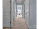 Hallway with carpet flooring and doors to bedrooms and bathroom at 7822 Meridale Forest Dr, Charlotte, NC 28269