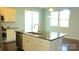 Bright kitchen featuring granite countertops, stainless dishwasher, and white cabinets at 7822 Meridale Forest Dr, Charlotte, NC 28269