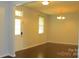 Bright living room with hardwood floors, ample natural light, and neutral paint at 7822 Meridale Forest Dr, Charlotte, NC 28269