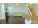 Spacious living room with a fireplace and open floor plan connecting to the kitchen and a staircase at 7822 Meridale Forest Dr, Charlotte, NC 28269